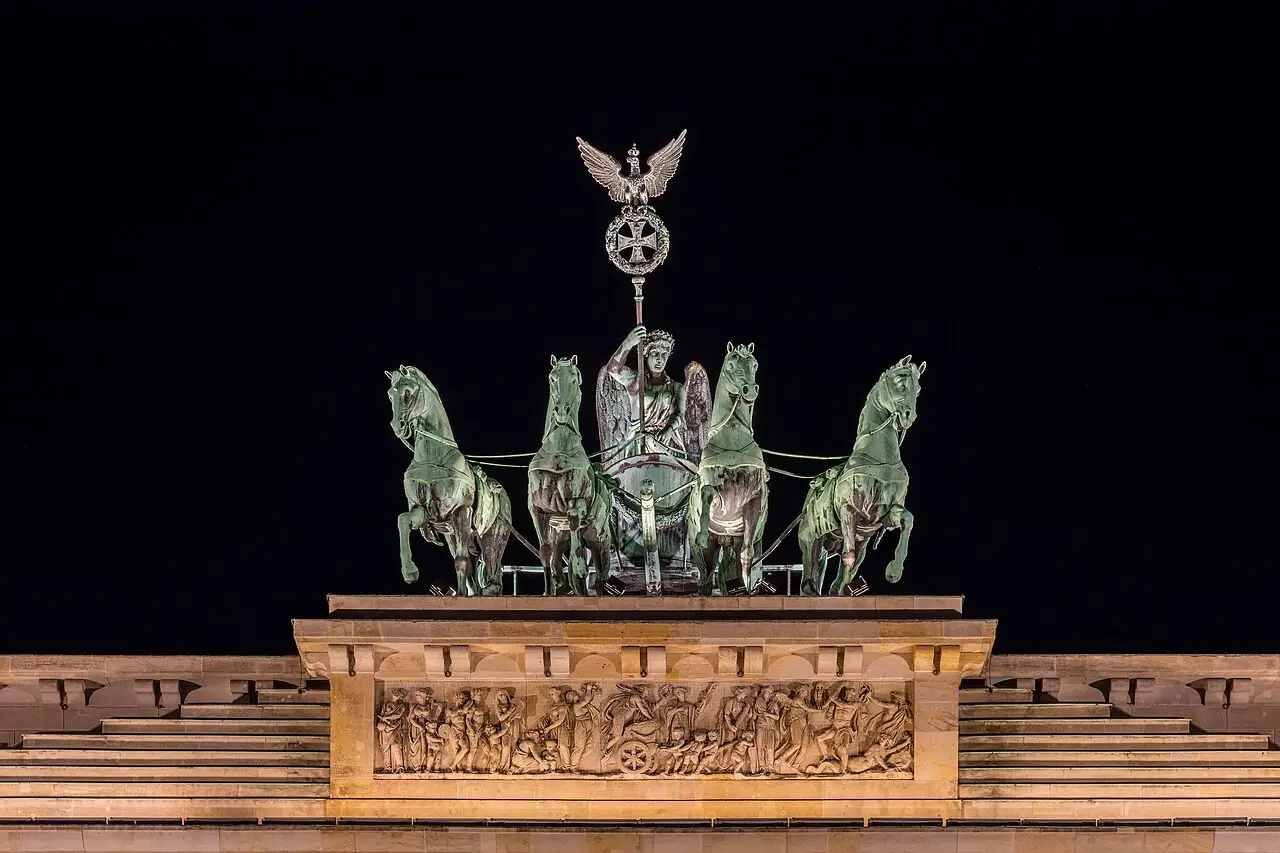 La emblemática Puerta de Brandeburgo iluminada durante la noche en el centro de Berlín.
